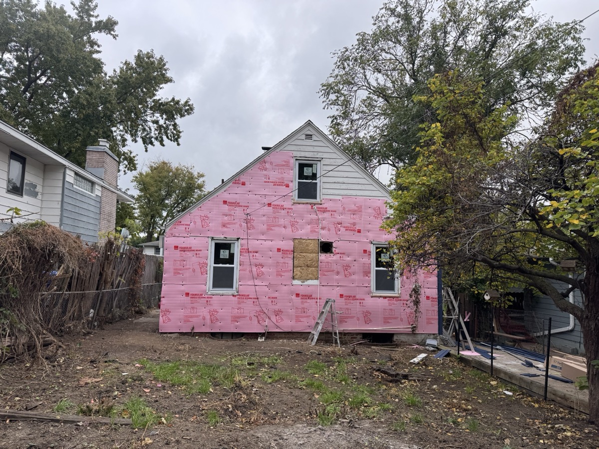Professional siding installation enhances curb appeal and weather protection. New vinyl siding panels being carefully fitted and aligned on a residential home exterior.